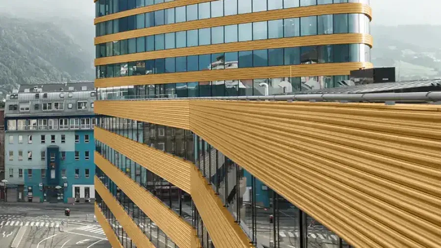 P1 tower and curved podium within Innsbruck’s cityscape
